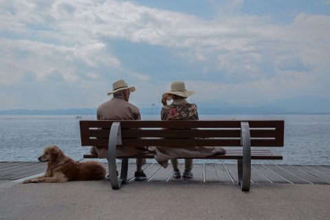 Elderly couple together on seaside bench